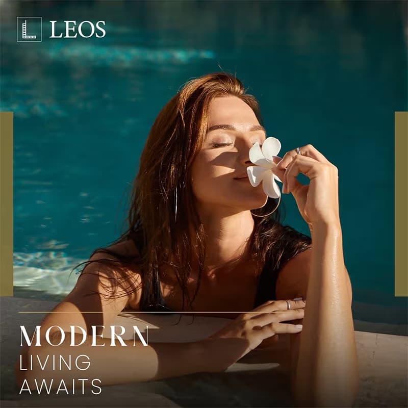 LEOS brand creative captioned Modern Living Awaits, showing a resident in a turquoise swimming pool